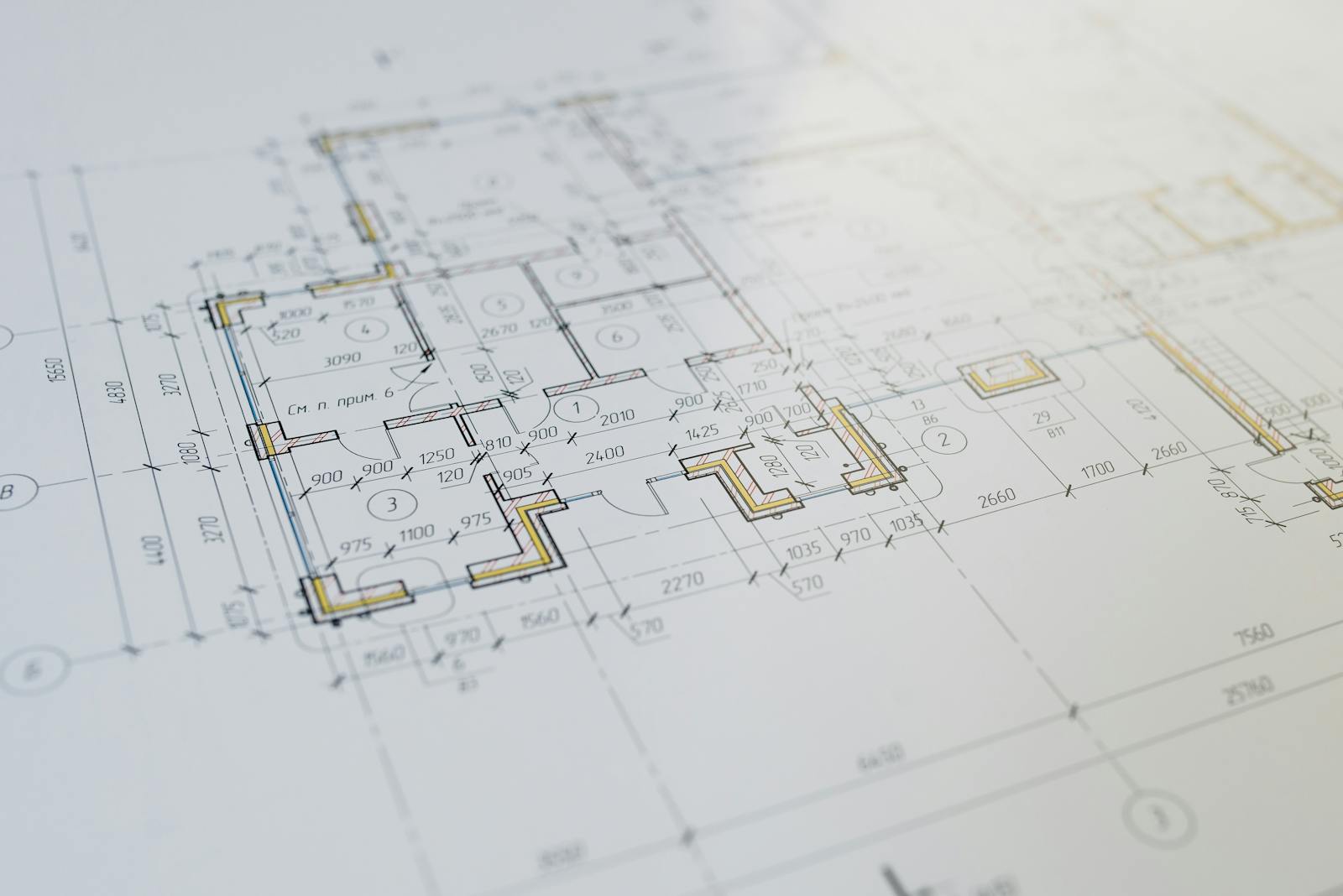Mesa de engenheiro com planta técnica, calculadora e capacete